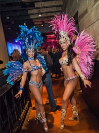 Two Samba Greeters dressed in feathers and jewels
